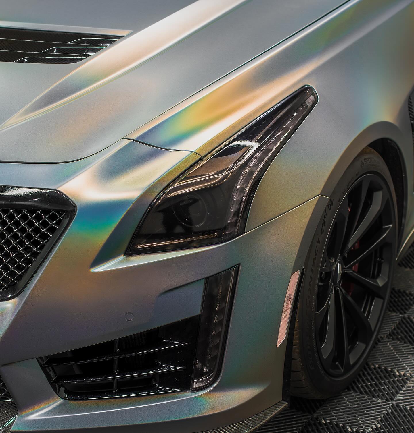 Background of a Cadillac CTS-V with Ceramic Coating applied. Serviced by Wrap Daddy's