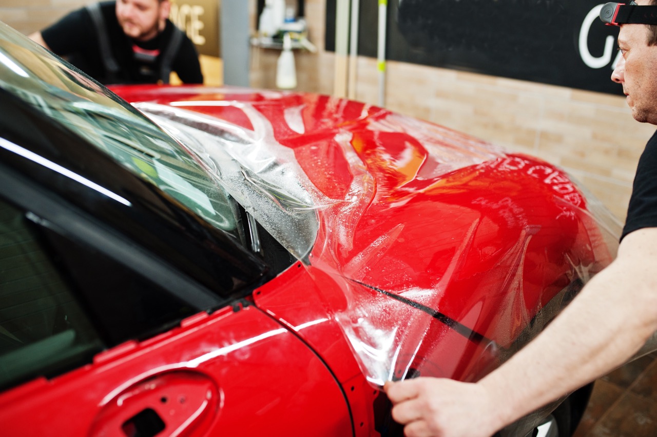 Paint protection film specialists installing paint protection film on a vehicle
